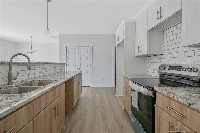 4905 High Branch Ct, Stedman, NC 28391 - kitchen featuring electric range, backsplash, light wood-style floors, light stone countertops, and crown molding