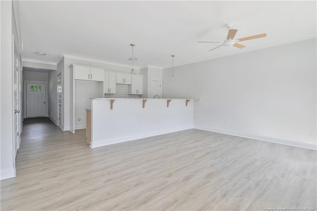 4905 High Branch Ct, Stedman, NC 28391 - unfurnished living room with light wood finished floors, a ceiling fan, and crown molding