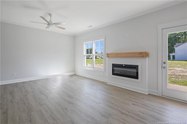 4905 High Branch Ct, Stedman, NC 28391 - unfurnished living room featuring a glass covered fireplace, wood finished floors, crown molding, and ceiling fan