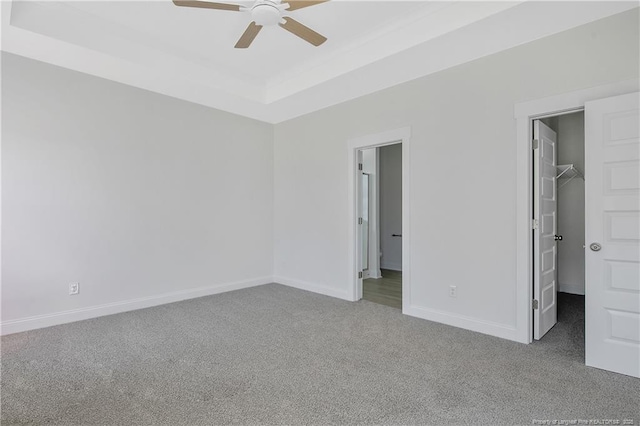 4905 High Branch Ct, Stedman, NC 28391 - unfurnished bedroom featuring carpet, a spacious closet, a tray ceiling, ceiling fan, and a closet