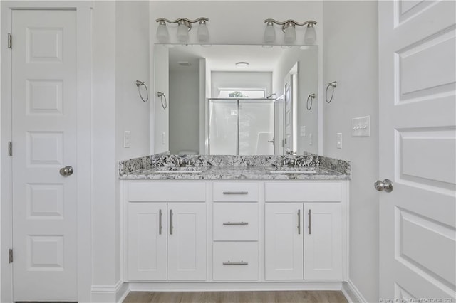 4905 High Branch Ct, Stedman, NC 28391 - bathroom with double vanity, a shower stall, and wood finished floors