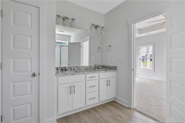 4905 High Branch Ct, Stedman, NC 28391 - bathroom featuring double vanity, wood finished floors, and a ceiling fan