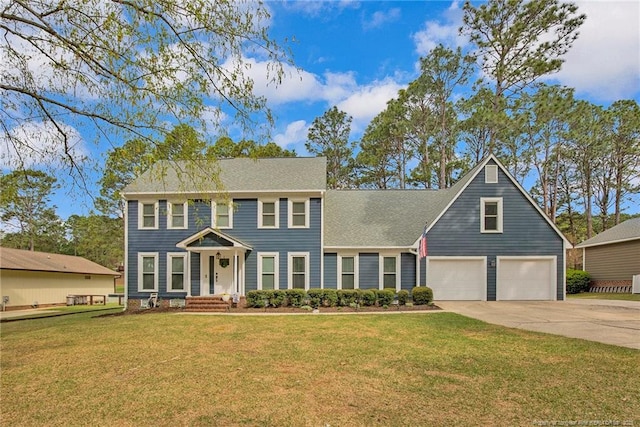 6868 Uppingham Rd, Fayetteville, NC 28306 - colonial house featuring an attached garage, driveway, and a front lawn
