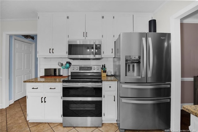 6868 Uppingham Rd, Fayetteville, NC 28306 - kitchen with appliances with stainless steel finishes, light tile patterned floors, white cabinets, stone counters, and ornamental molding