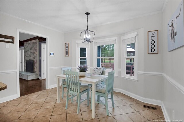 6868 Uppingham Rd, Fayetteville, NC 28306 - dining room featuring a notable chandelier, ornamental molding, and light tile patterned floors