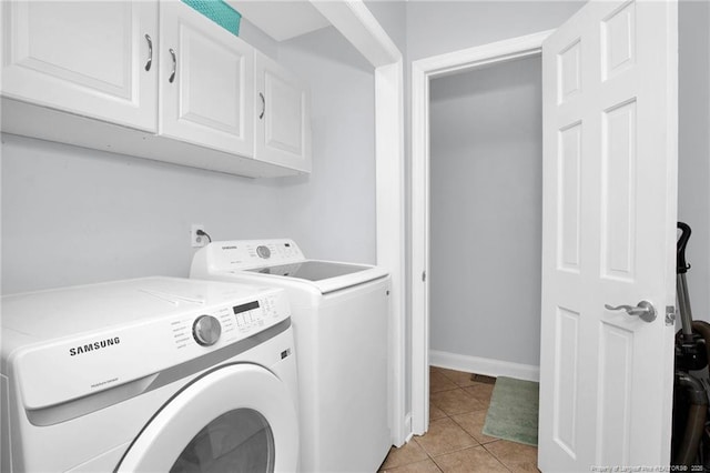 6868 Uppingham Rd, Fayetteville, NC 28306 - laundry room featuring light tile patterned floors, baseboards, cabinet space, and washer and dryer