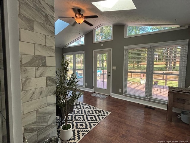 6868 Uppingham Rd, Fayetteville, NC 28306 - entryway with visible vents, wood finished floors, baseboards, ceiling fan, and vaulted ceiling with skylight