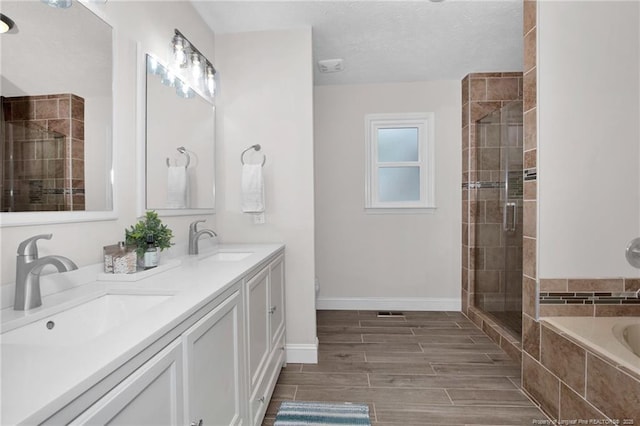 6868 Uppingham Rd, Fayetteville, NC 28306 - bathroom with baseboards, tiled shower, a sink, and tiled tub