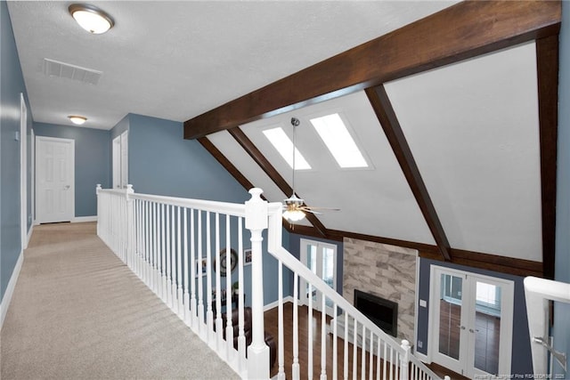6868 Uppingham Rd, Fayetteville, NC 28306 - hall featuring a textured ceiling, baseboards, visible vents, and lofted ceiling with skylight