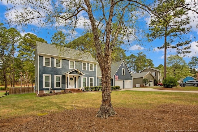 6868 Uppingham Rd, Fayetteville, NC 28306 - colonial house with a front lawn, fence, and driveway