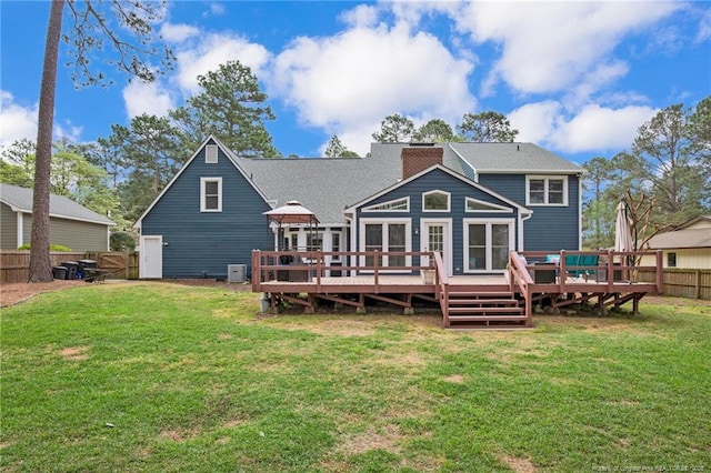 6868 Uppingham Rd, Fayetteville, NC 28306 - back of property featuring a lawn, fence, a wooden deck, and a chimney