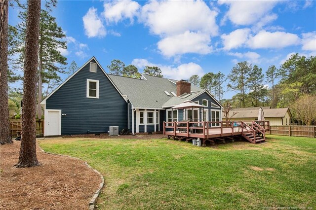 6868 Uppingham Rd, Fayetteville, NC 28306 - back of property featuring a chimney, roof with shingles, a deck, fence, and a yard
