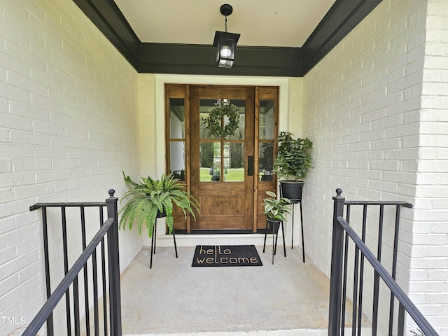 view of exterior entry featuring brick siding