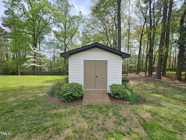 view of shed featuring fence