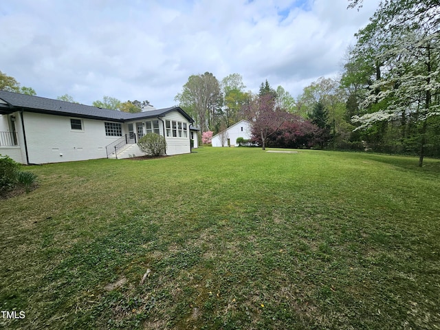 view of yard with a sunroom