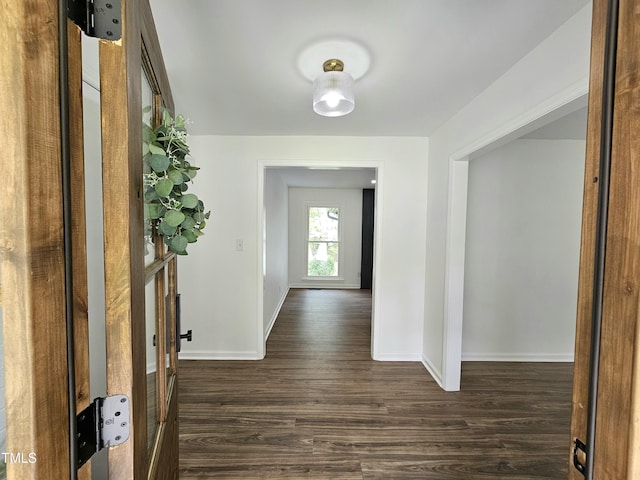 hall with baseboards and dark wood finished floors