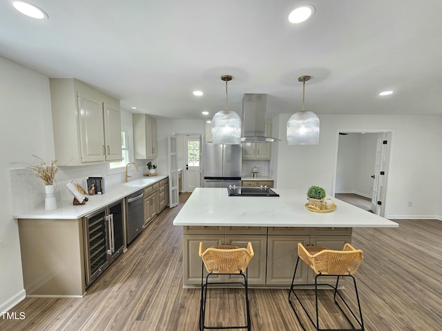 kitchen featuring a kitchen island, wood finished floors, beverage cooler, stainless steel appliances, and island range hood