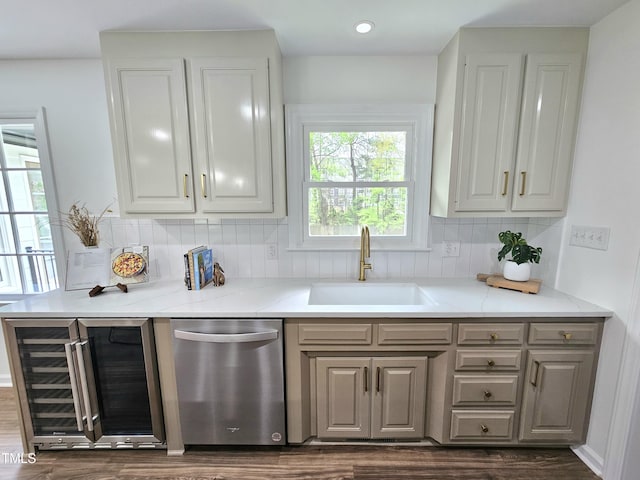 kitchen with dishwasher, a sink, wine cooler, white cabinetry, and decorative backsplash