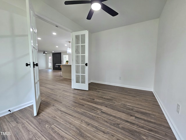 empty room with french doors, dark wood-style flooring, baseboards, and ceiling fan