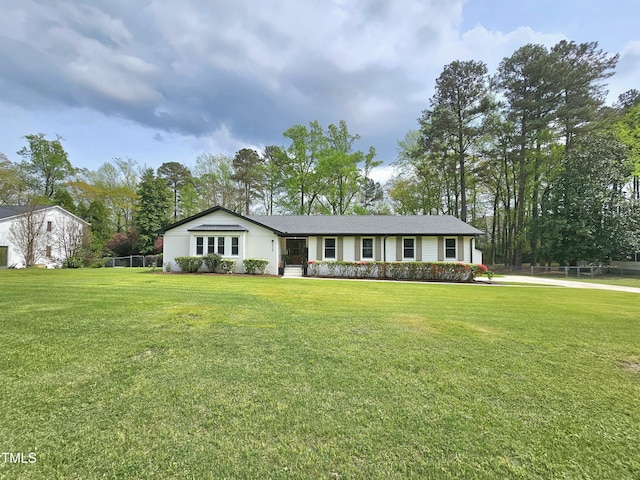 ranch-style house with a front yard and fence