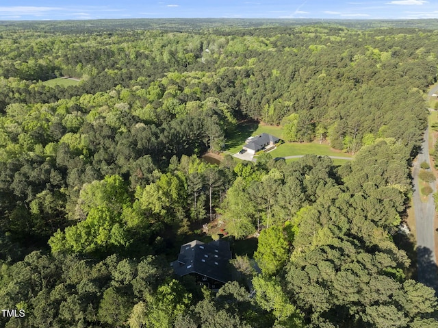 aerial overview of property's location with a heavily wooded area