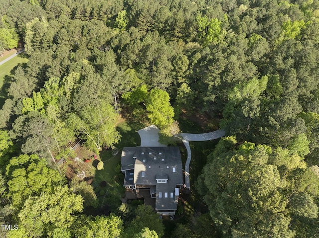 view of property location featuring a forest