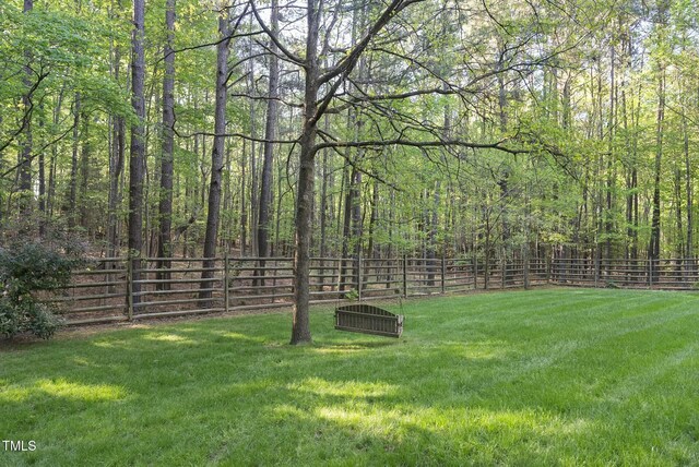 view of yard with a view of trees