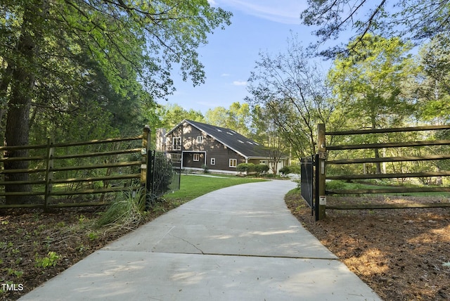 surrounding community with a gate and driveway