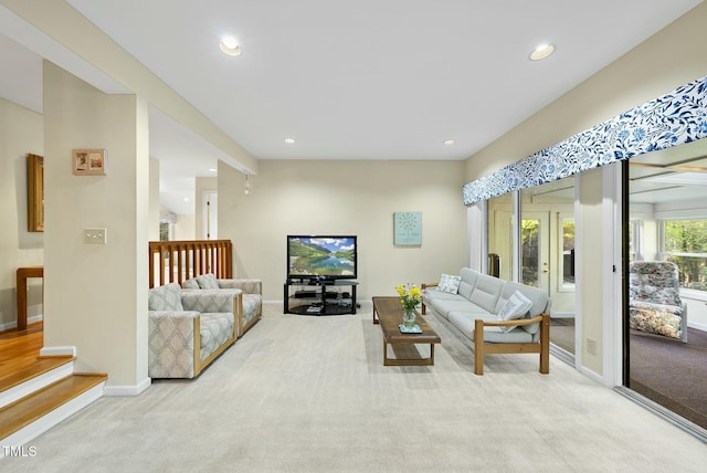 carpeted living area with recessed lighting and baseboards