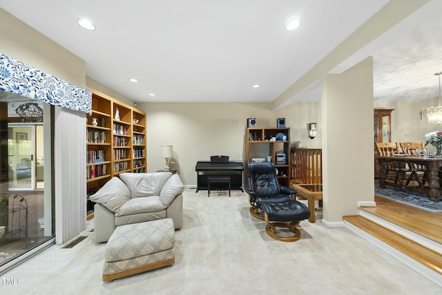 living area with carpet floors, a chandelier, recessed lighting, and baseboards