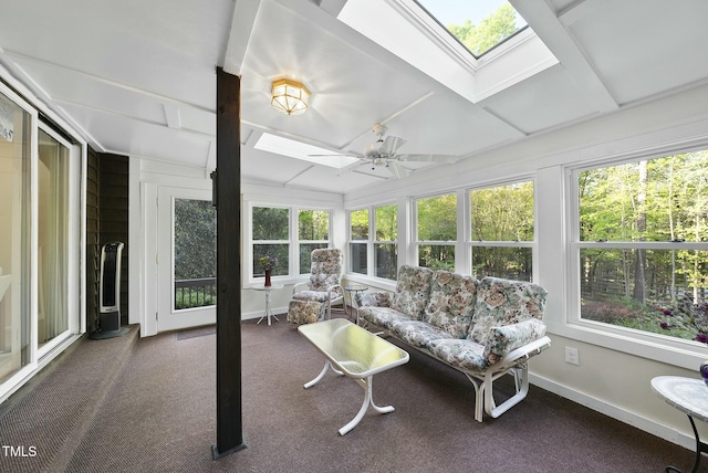 sunroom / solarium with a skylight, plenty of natural light, baseboards, and carpet floors