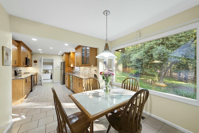 dining area featuring healthy amount of natural light, light tile patterned floors, baseboards, and recessed lighting