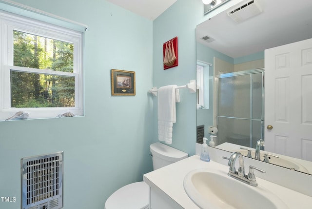 full bath with heating unit, toilet, a shower stall, and vanity