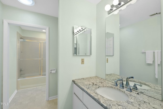 full bathroom with baseboards, vanity, and enclosed tub / shower combo