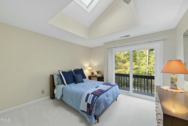 bedroom with light colored carpet, access to exterior, a skylight, baseboards, and lofted ceiling