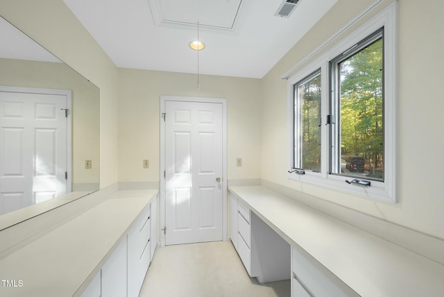washroom featuring attic access and a desk