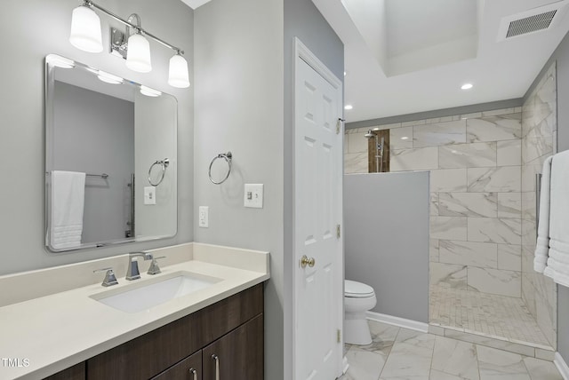bathroom with marble look tiles, toilet, walk in shower, vanity, and recessed lighting