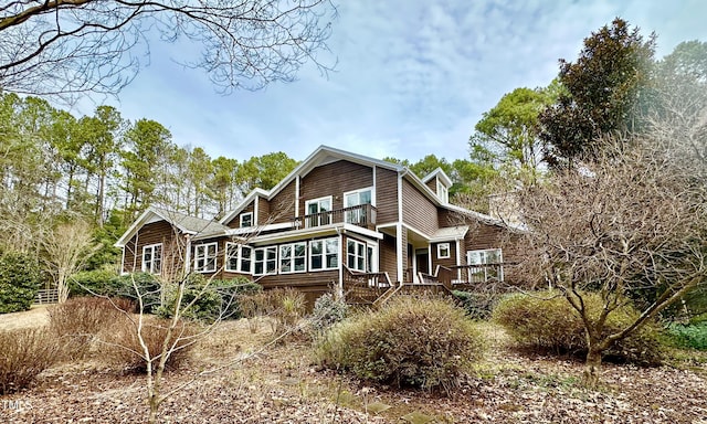 rear view of house featuring a deck