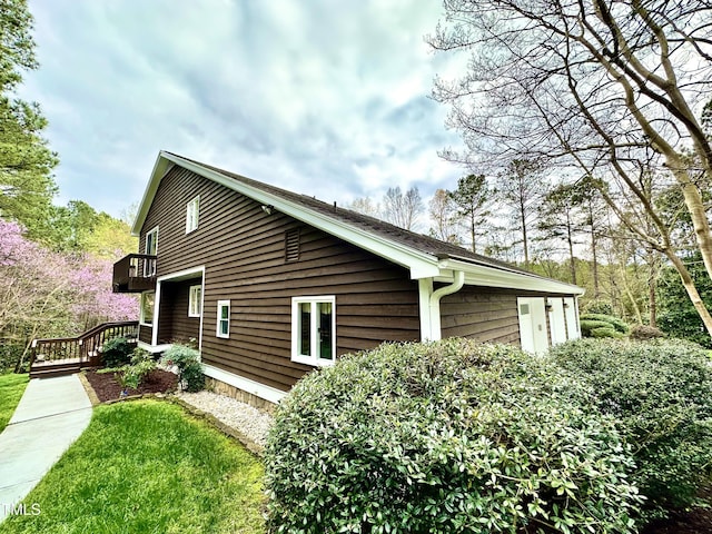 view of property exterior with a wooden deck
