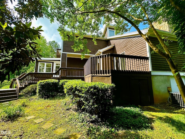 back of house featuring a wooden deck