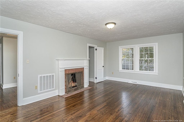 unfurnished living room featuring baseboards, wood finished floors, and visible vents