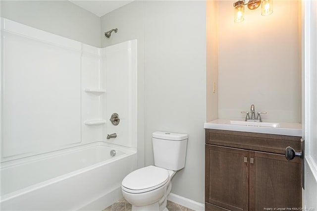 bathroom featuring toilet, vanity,  shower combination, and baseboards