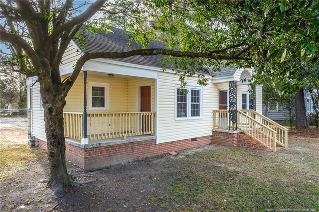 view of front of home with crawl space and a shingled roof