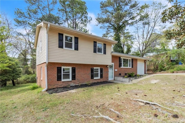 split level home featuring an attached garage, brick siding, and a front lawn