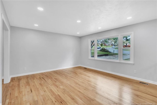 unfurnished room with baseboards, light wood-style floors, and recessed lighting