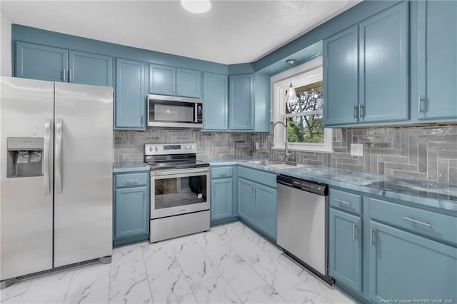 kitchen with a sink, backsplash, blue cabinets, stainless steel appliances, and marble finish floor