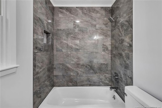 bathroom featuring bathtub / shower combination and toilet