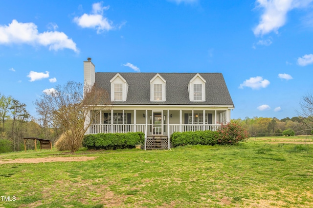 new england style home with a chimney, a shingled roof, a front lawn, and a porch