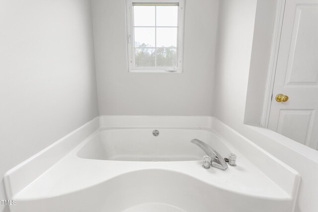 bathroom with a garden tub