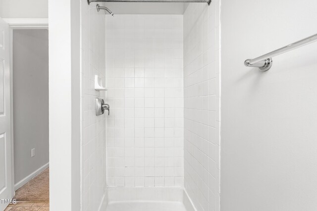 bathroom with tiled shower
